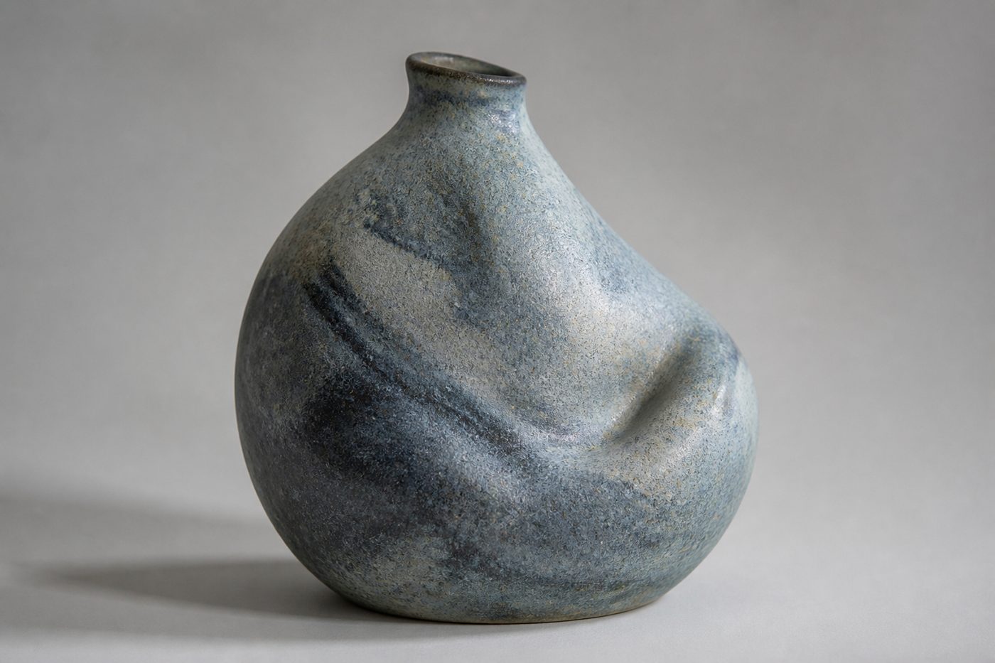 Single sculptural stoneware vessel on a quiet studio field